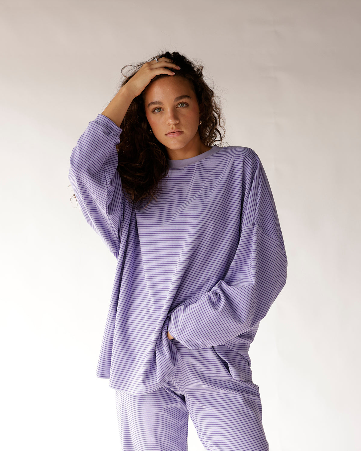 Oversized lavender striped long sleeve top with relaxed fit and crew neck