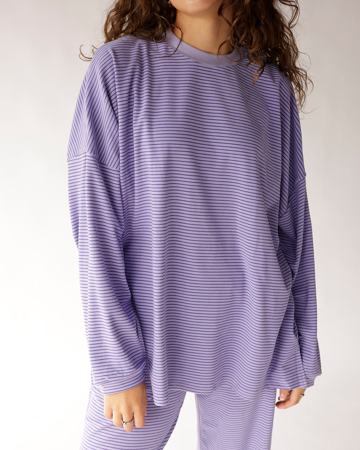 Oversized lavender striped long-sleeve top with relaxed fit and crew neck