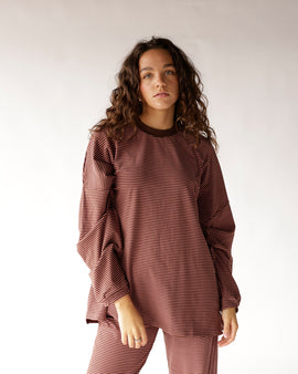 Stay effortlessly stylish in this pink and brown striped oversized top featuring a brown ribbed crew neckline, dropped shoulders, and a relaxed boxy fit. The perfect everyday essential for denim, biker shorts, and casual weekend outfits.
