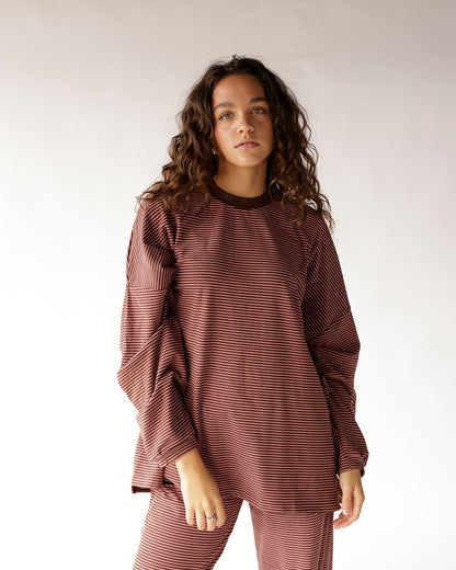 Stay effortlessly stylish in this pink and brown striped oversized top featuring a brown ribbed crew neckline, dropped shoulders, and a relaxed boxy fit. The perfect everyday essential for denim, biker shorts, and casual weekend outfits.