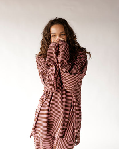 Oversized striped long sleeve top in rust red and cream worn casually