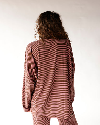 Oversized long sleeve top in mauve with thin white horizontal stripes, back view
