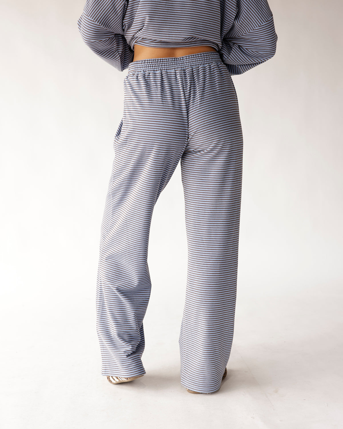 Dusty blue striped wide leg pants with elastic waistband, back view