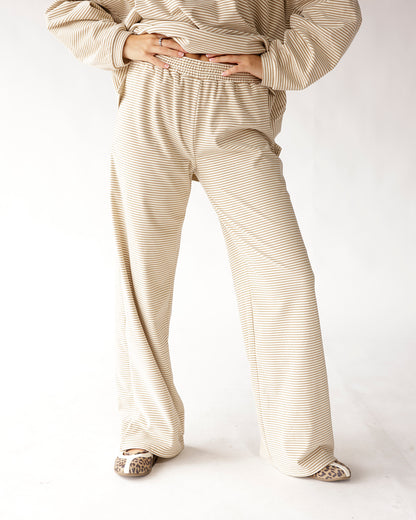 Oatmeal striped wide leg pants with elastic waistband, paired with leopard flats