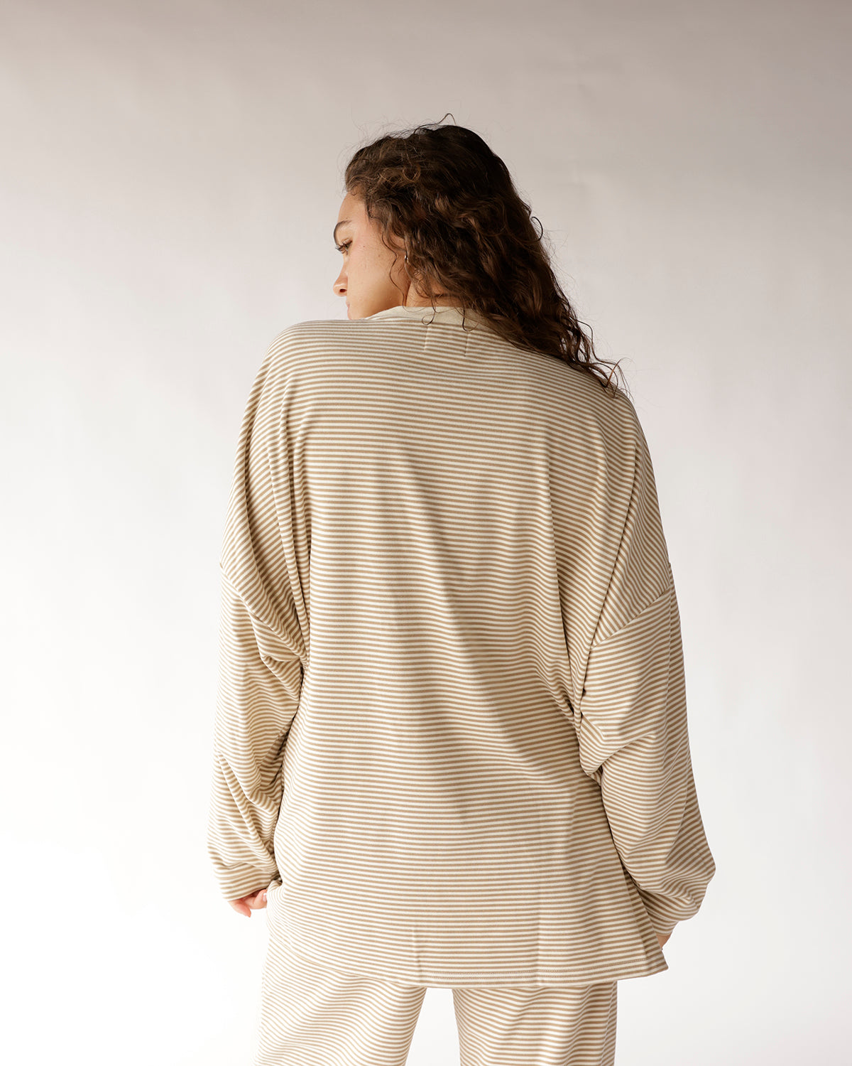 Oversized striped long sleeve top in oatmeal and cream, back view