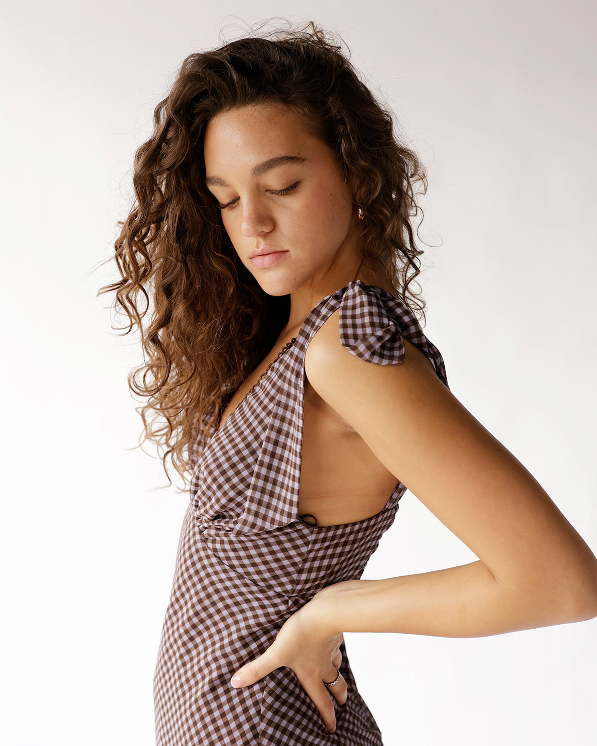 Blackberry gingham mini dress with bow shoulder straps and deep V neckline