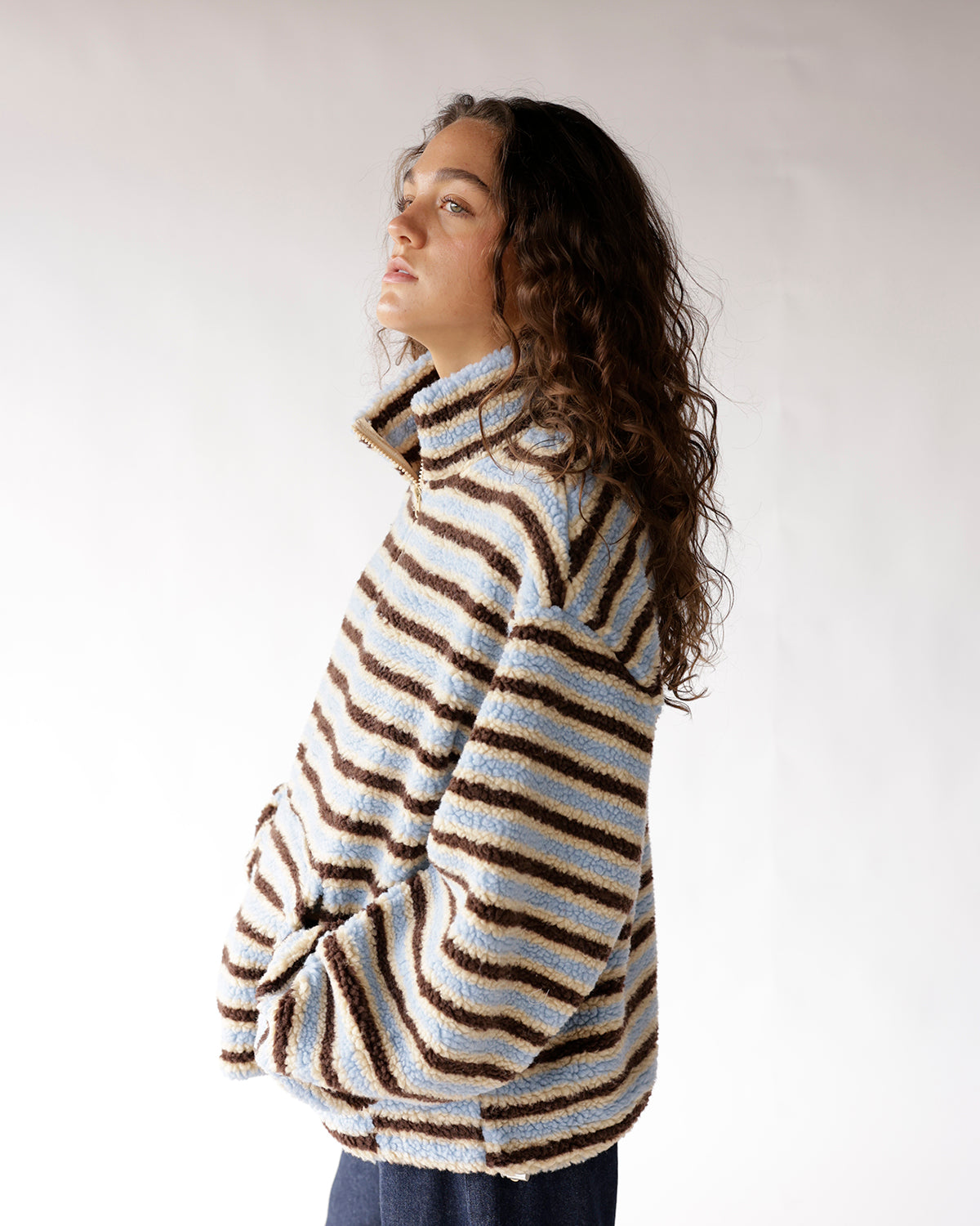 Blue striped sherpa quarter-zip pullover with brown and cream stripes, oversized fit