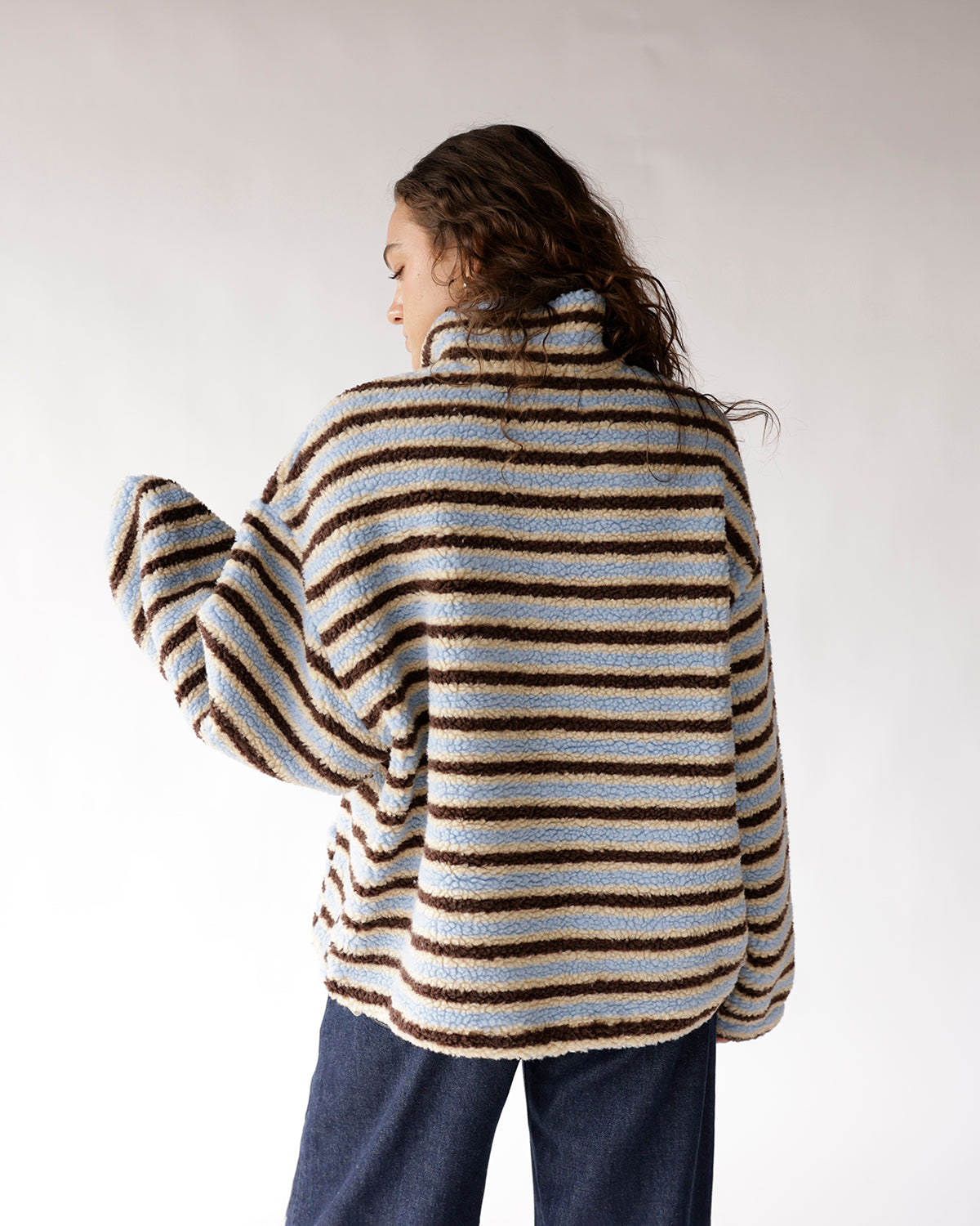 Striped blue, cream, and brown sherpa pullover with turtleneck, back view