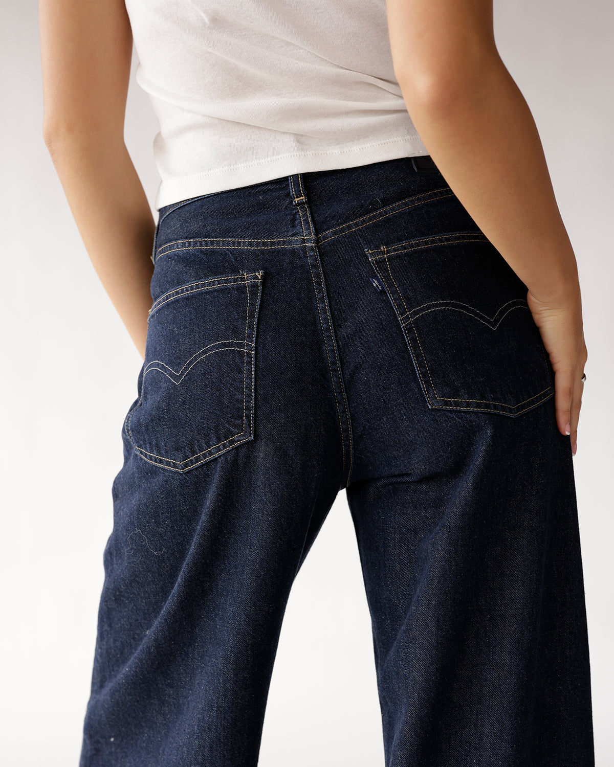 Back view of dark indigo wide-leg jeans with contrast stitching and back pockets