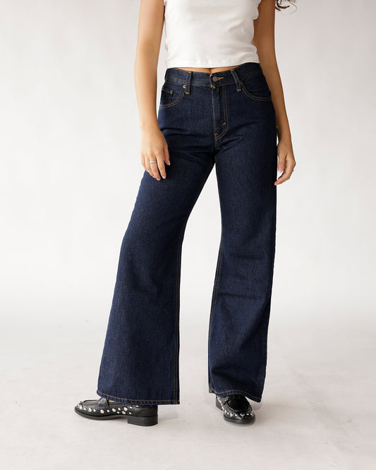 Dark indigo wide-leg flare jeans with contrast stitching, high waist, five-pocket styling
