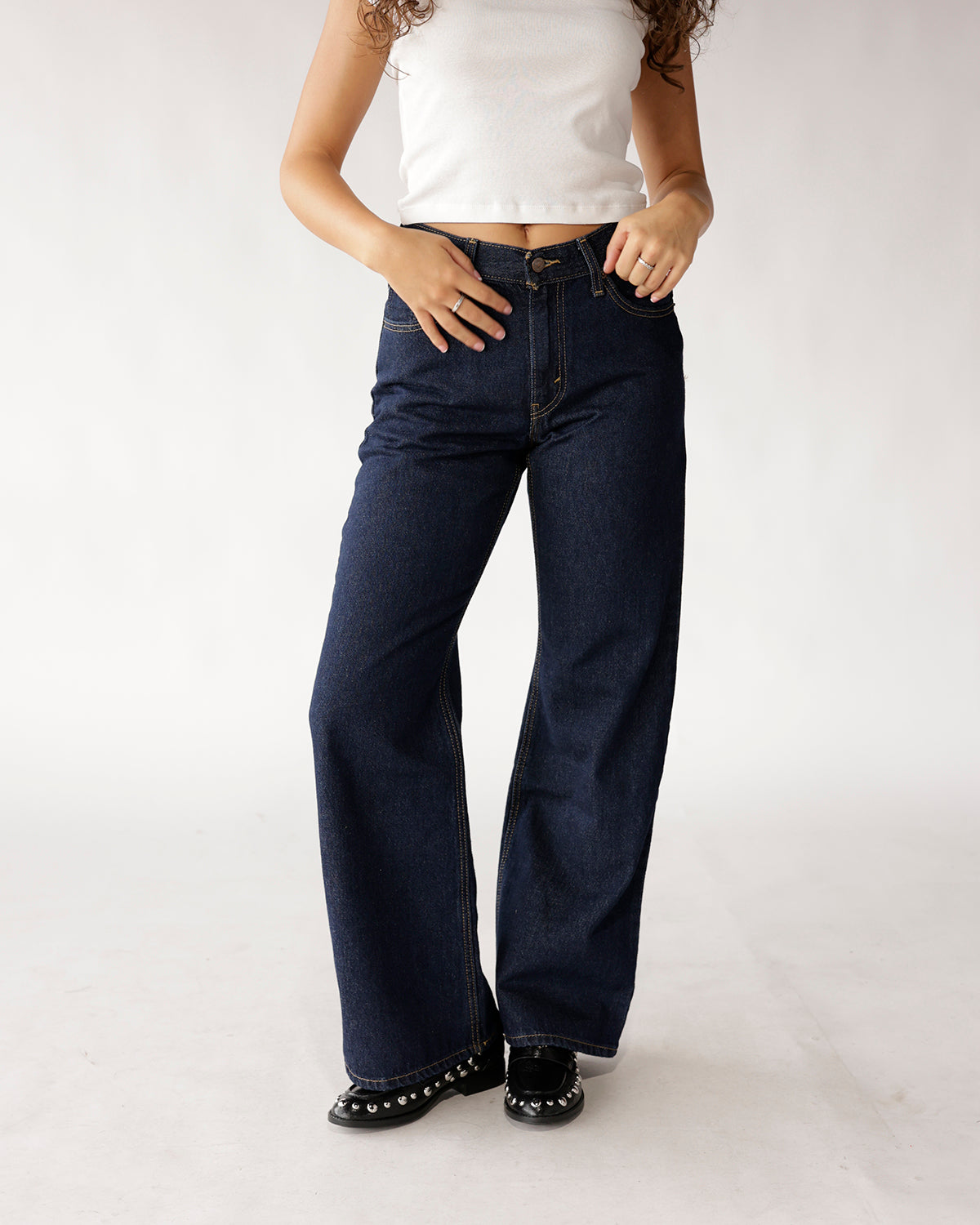 Dark indigo wide-leg boot cut jeans with contrast stitching, high rise fit