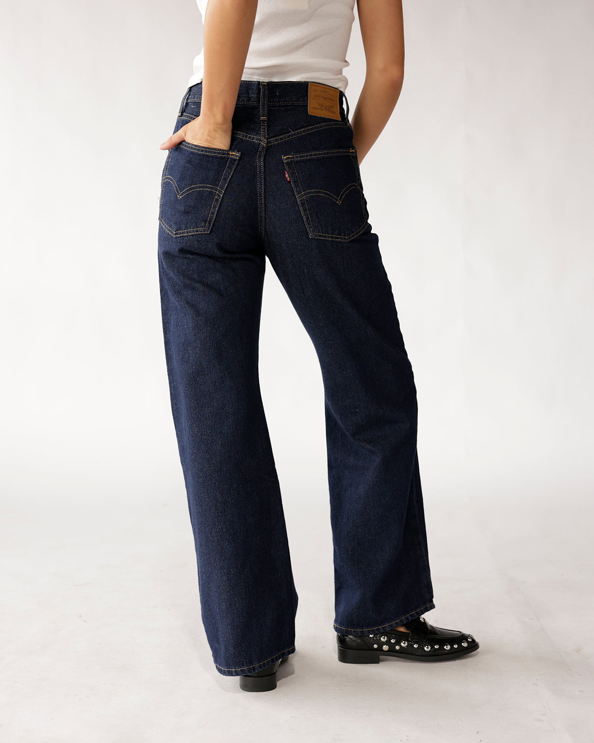 Dark navy wide-leg boot cut jeans, back view, with contrast stitching
