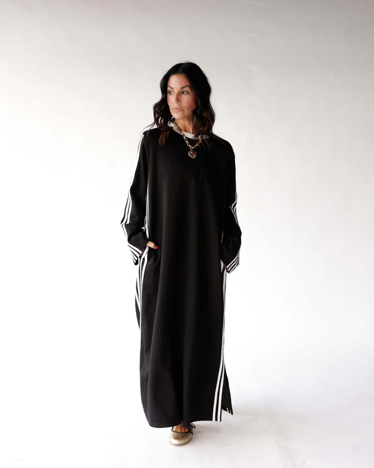 Black maxi dress with white varsity stripes on sleeves and sides, long sleeve
