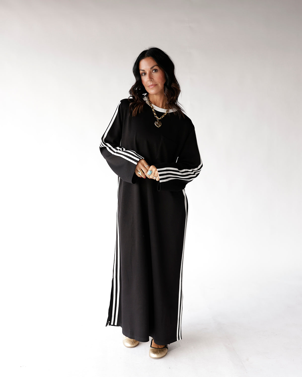 Black maxi track dress with white side stripes and long sleeves
