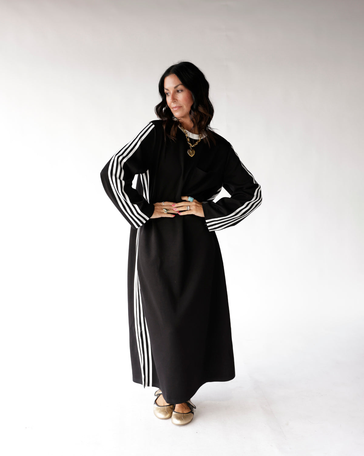 Black maxi track dress with white varsity stripes on sleeves and sides