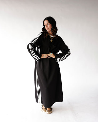 Black maxi track dress with white varsity stripes on sleeves and sides