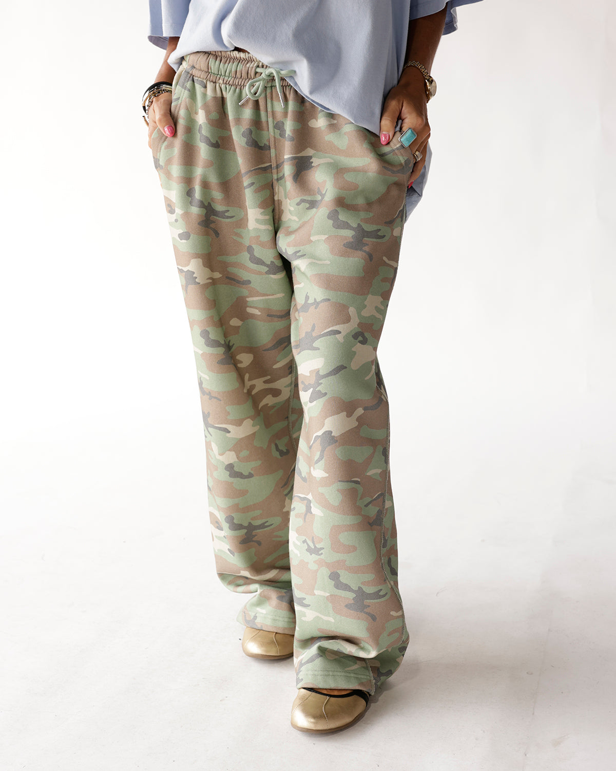 Wide-leg camo sweatpants with drawstring waist, green and tan camouflage pattern