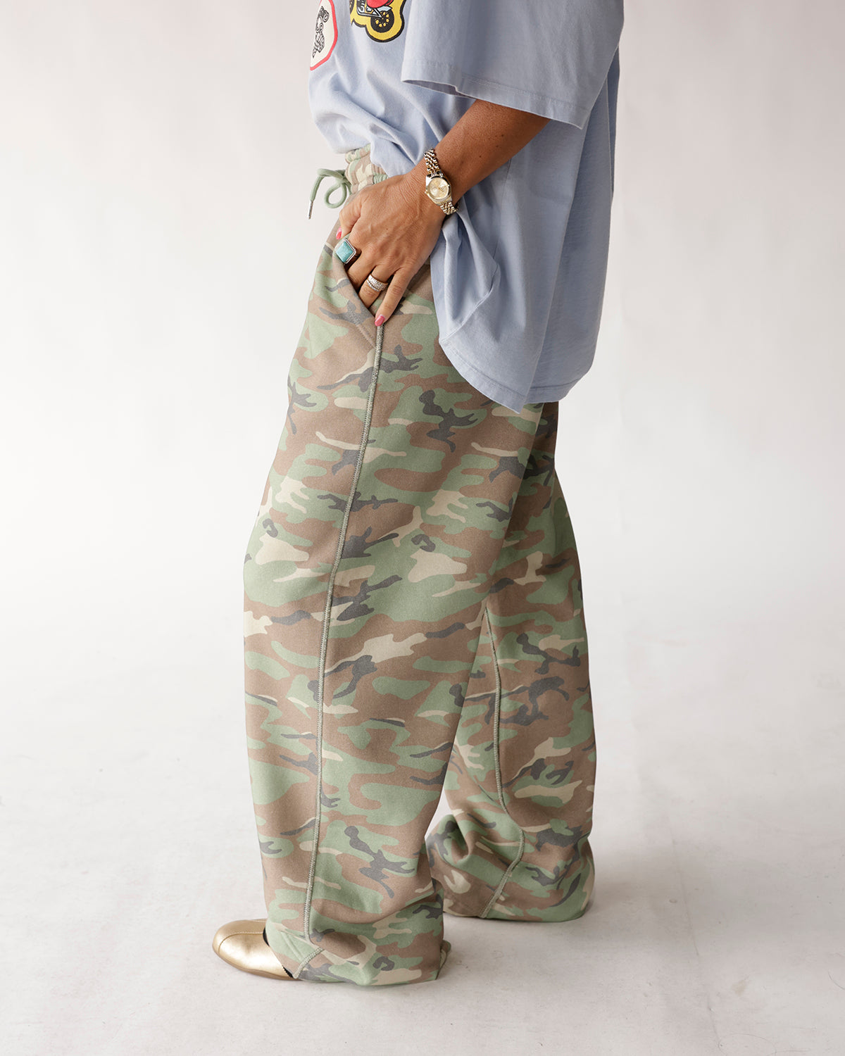 Oversized wide-leg camo sweatpants in green and tan with drawstring waist