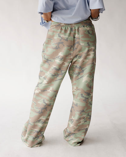 Oversized wide-leg camo sweatpants in green, tan, and gray with elastic waist