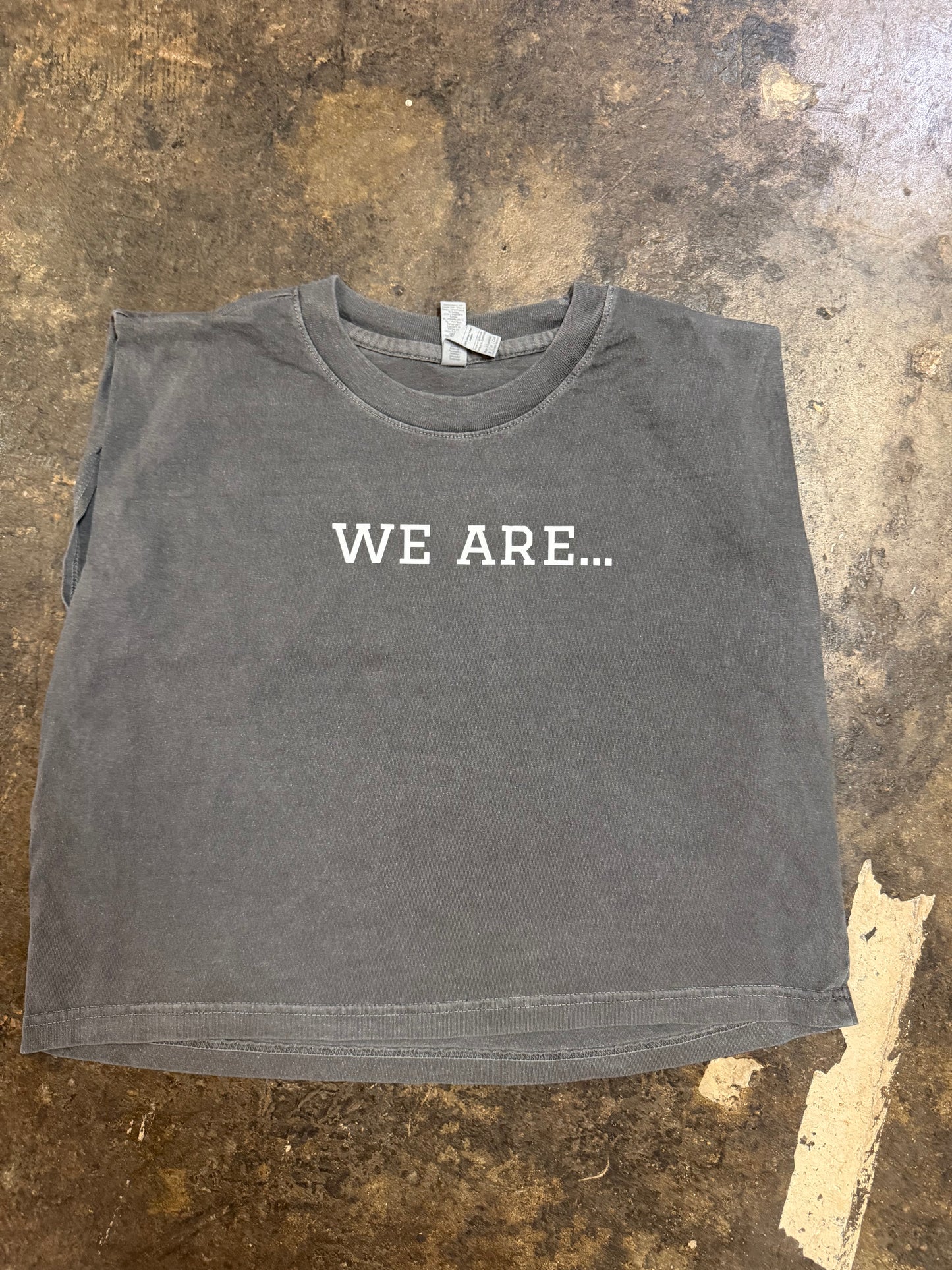 Vintage washed black sleeveless crop muscle tee with WE ARE... text graphic