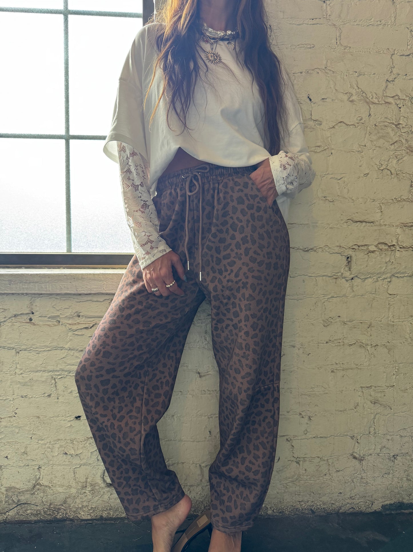 HIP LEANING INTO LEOPARD BARREL JOGGER