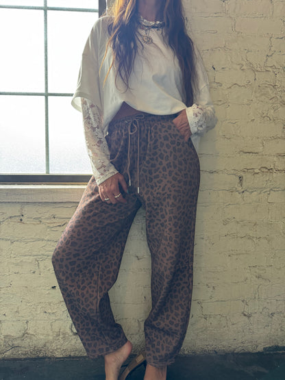 HIP LEANING INTO LEOPARD BARREL JOGGER