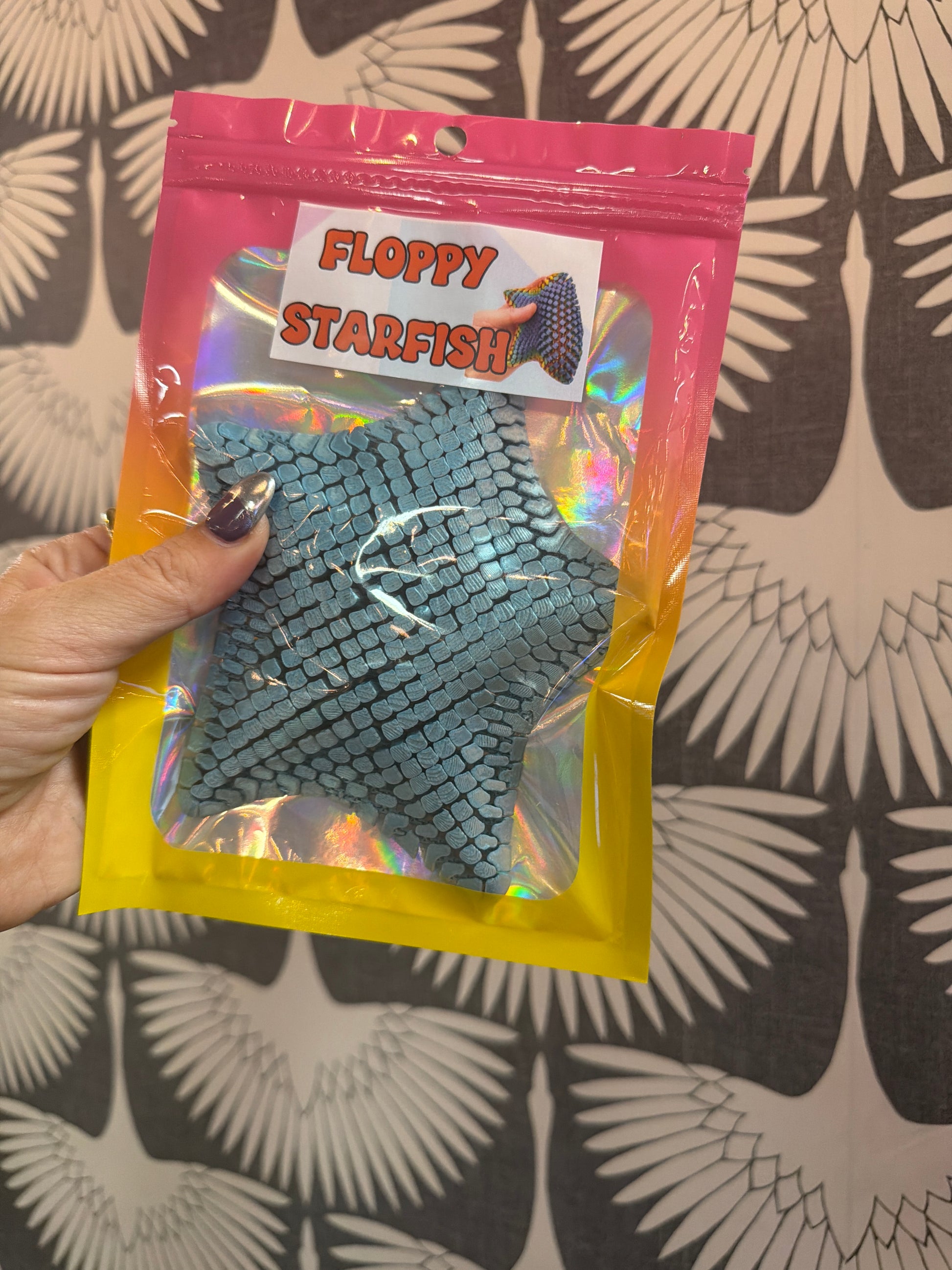 PYE Games Floppy Starfish fidget toy, teal scaled flexible sensory star in holographic bag