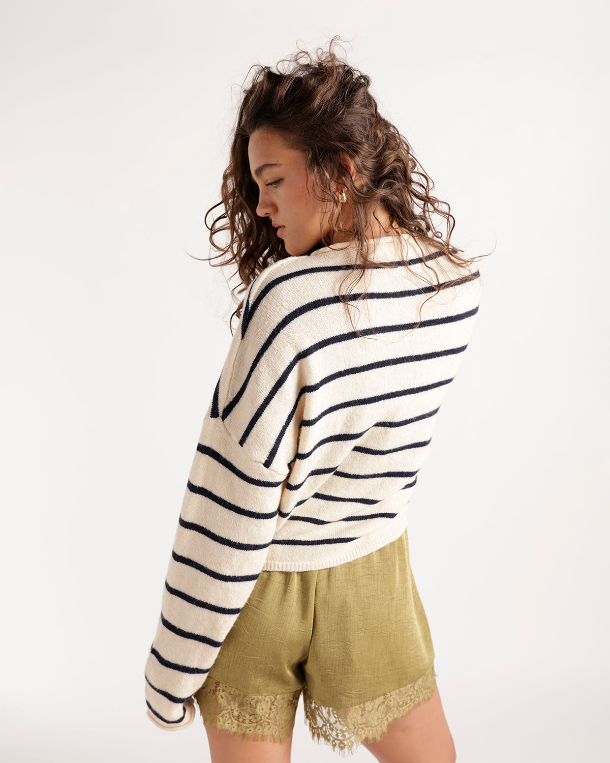 Ivory and navy striped knit cardigan paired with olive lace-trim shorts
