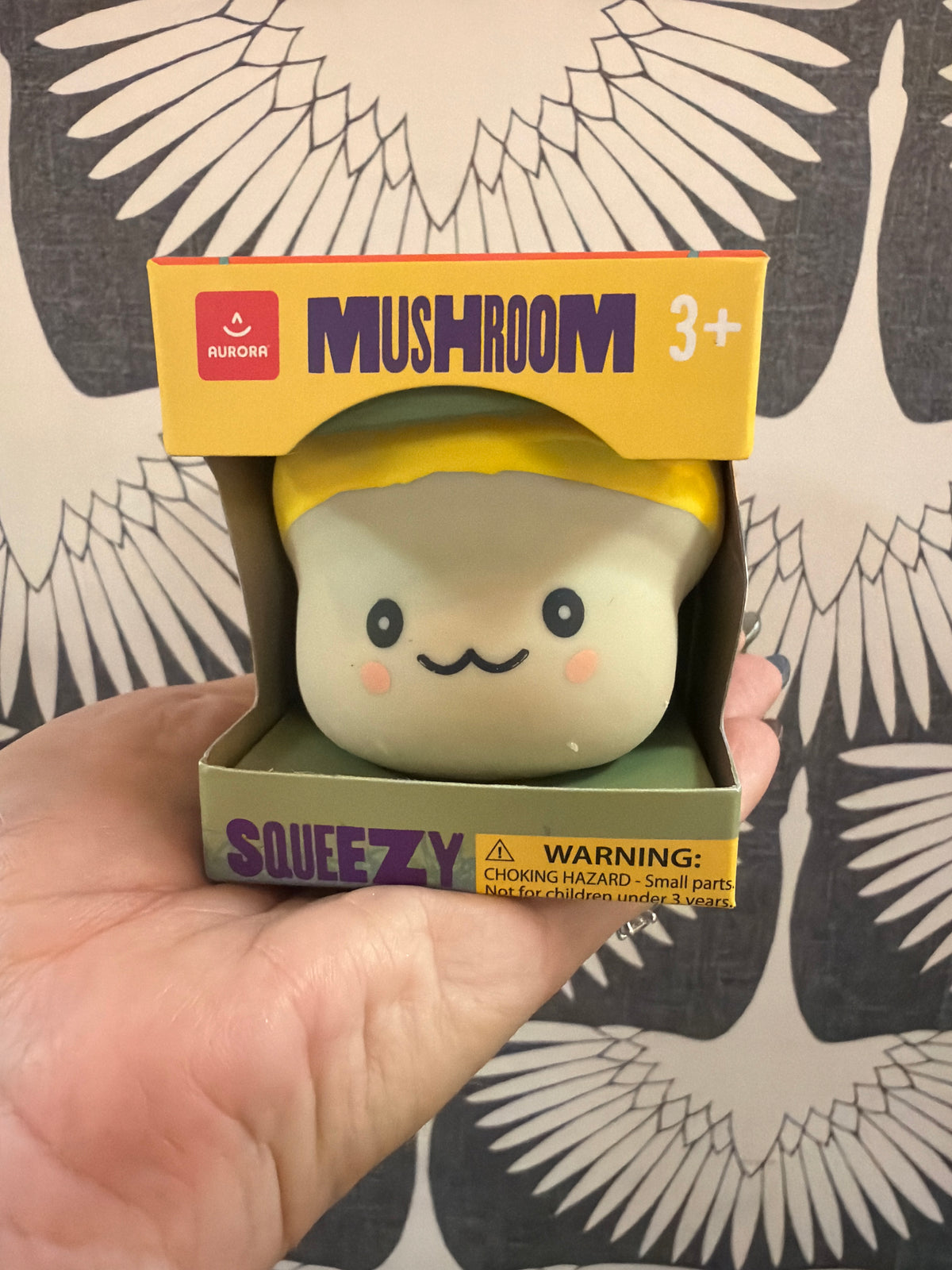 Aurora Mushroom Squeezy toy, cream and yellow squishy figure with cute smiling face, in box