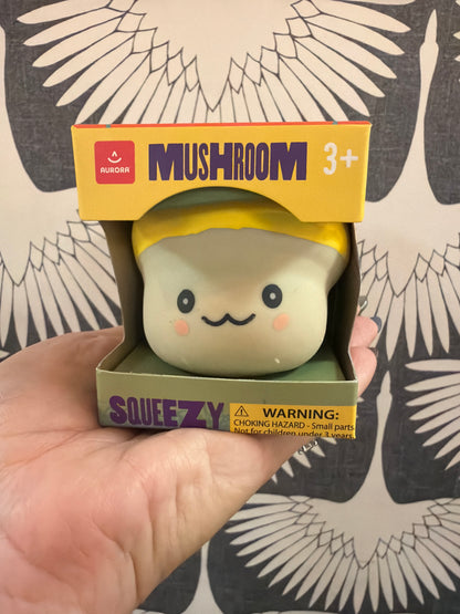 Aurora Mushroom Squeezy toy, cream and yellow squishy figure with cute smiling face, in box