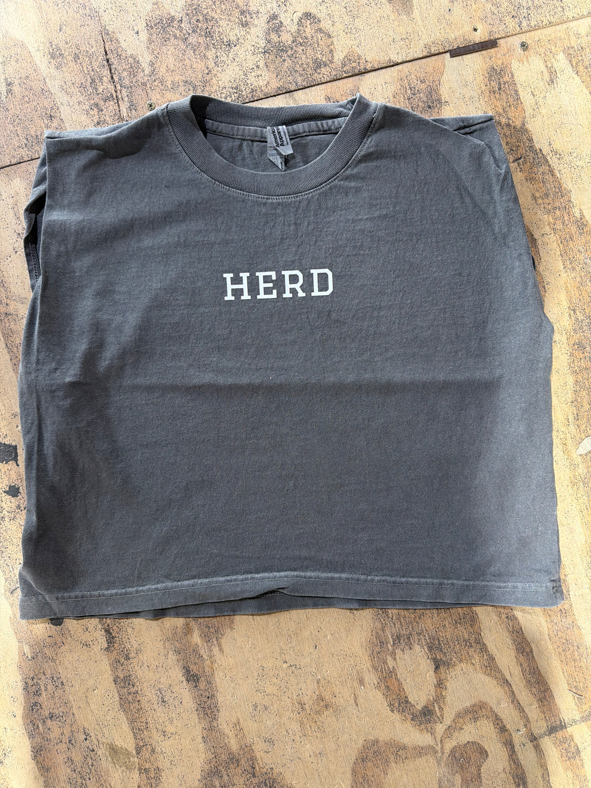 Vintage black cropped muscle tee with white HERD text on chest
