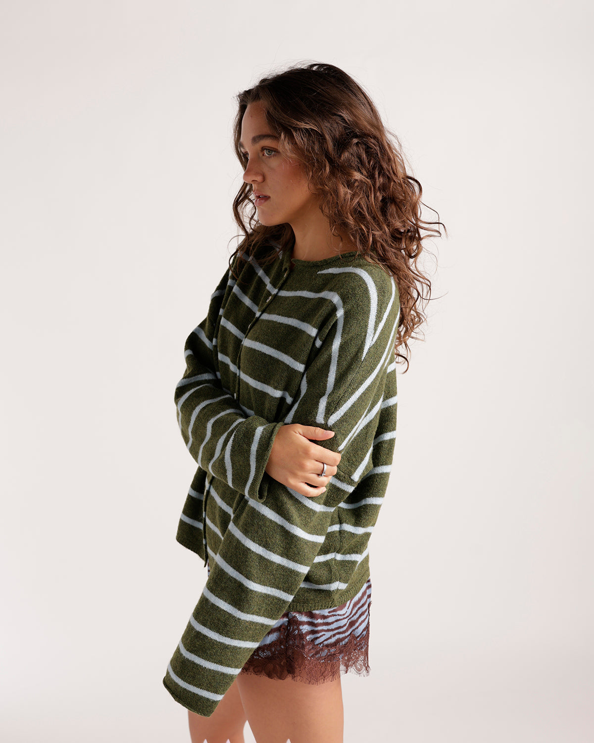 Olive green and baby blue striped knit cardigan with long sleeves, worn open