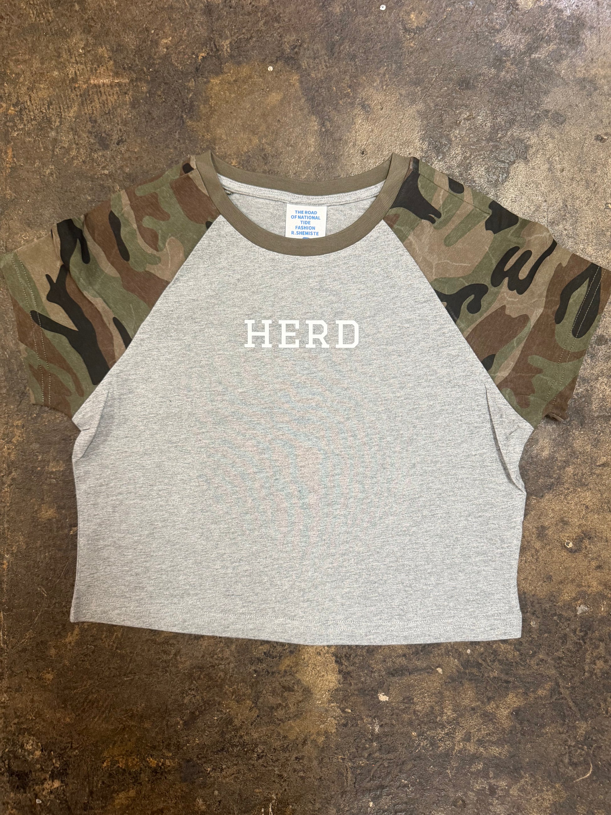 Gray crop raglan tee with camo sleeves and white HERD chest graphic