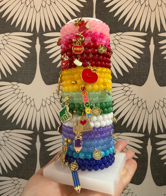 Adorable girls’ back-to-school beaded charm bracelets featuring colorful beads and a fun school-themed charm. Perfect for stacking and gifting!