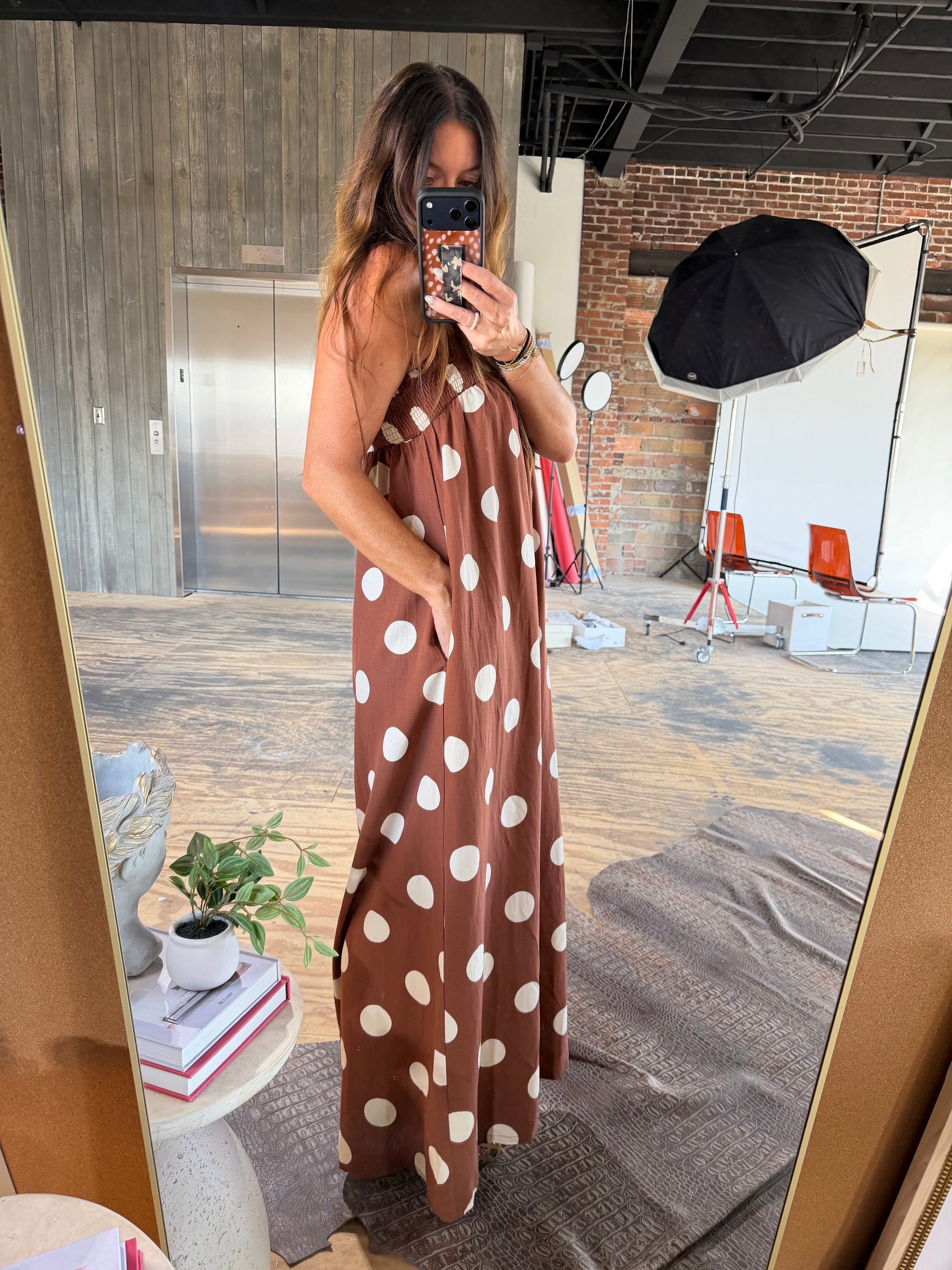 Brown polka dot sleeveless maxi dress with white dots and relaxed silhouette