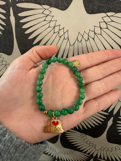 Green beaded stretch bracelet with gold and red I Love School charm