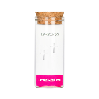 Silver cross stud earrings displayed inside a small clear glass bottle with cork lid