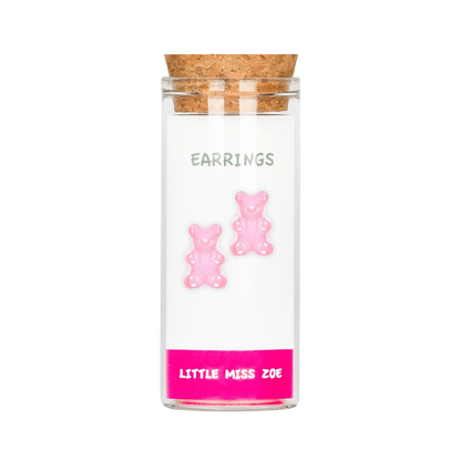 Pink gummy bear stud earrings displayed inside a small glass bottle with cork lid