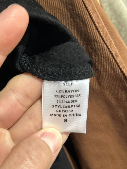Black dressy pants clothing label showing size small, rayon polyester spandex blend