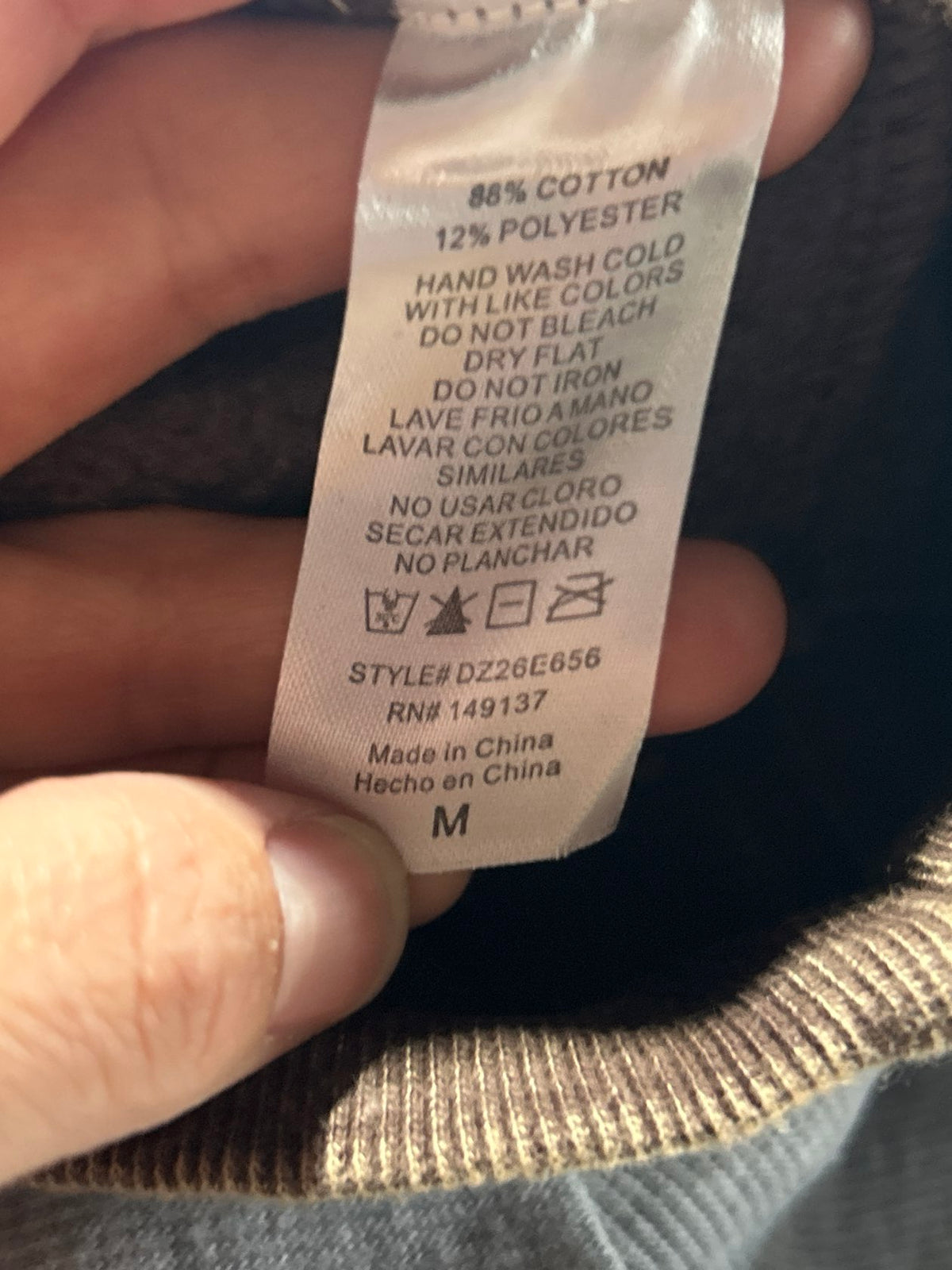 Clothing label showing 88% cotton 12% polyester size medium hand wash cold care instructions