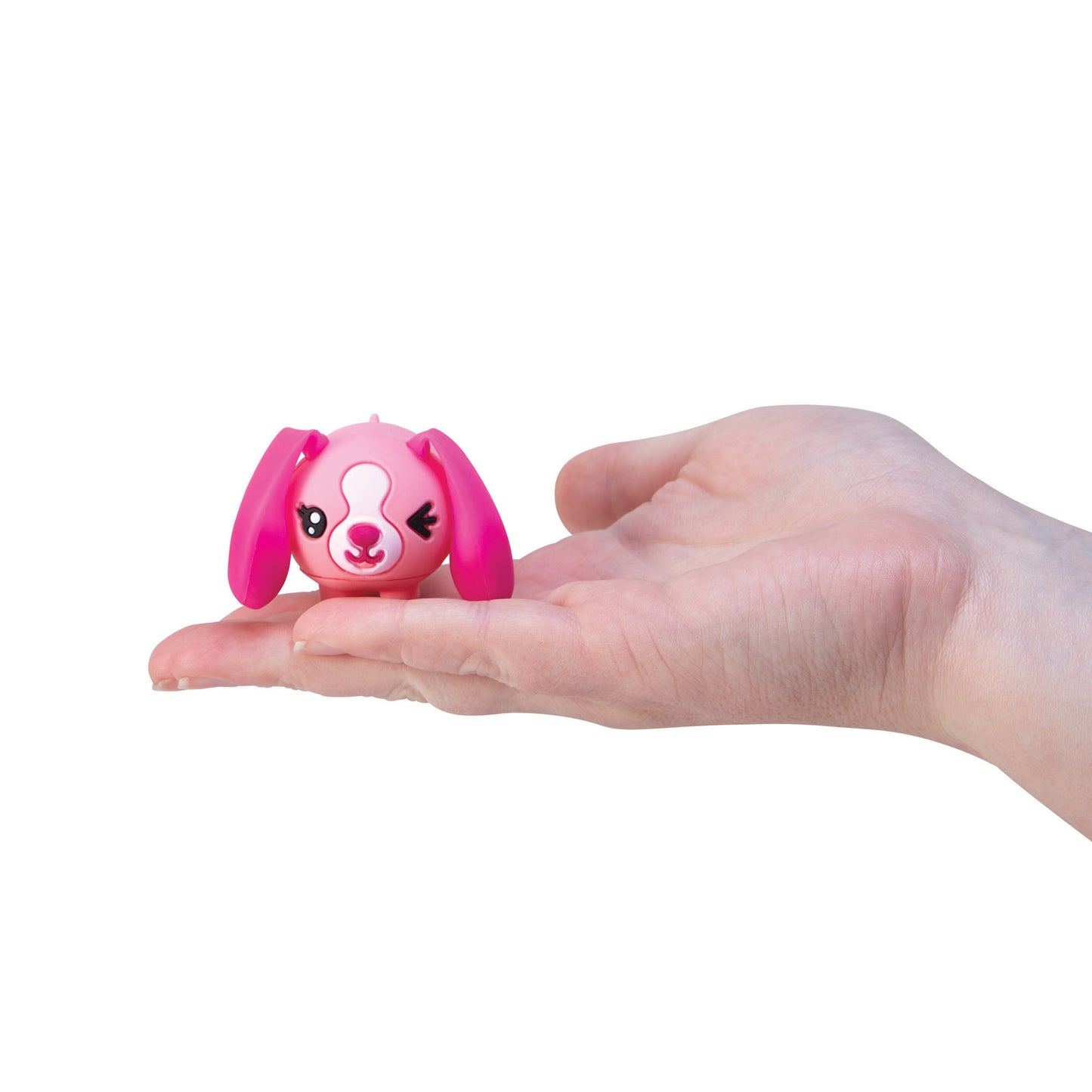 Tiny pink bunny toy figurine resting in the palm of a hand