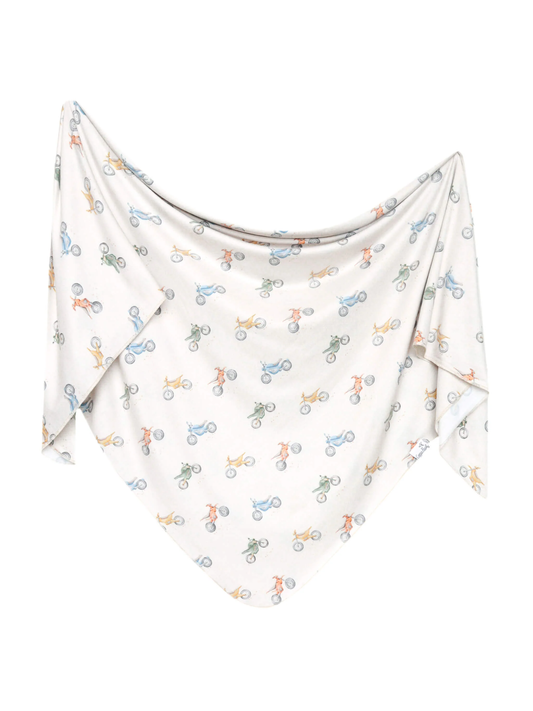 Copper Pearl white swaddle blanket with colorful dirt bike motorcycle print