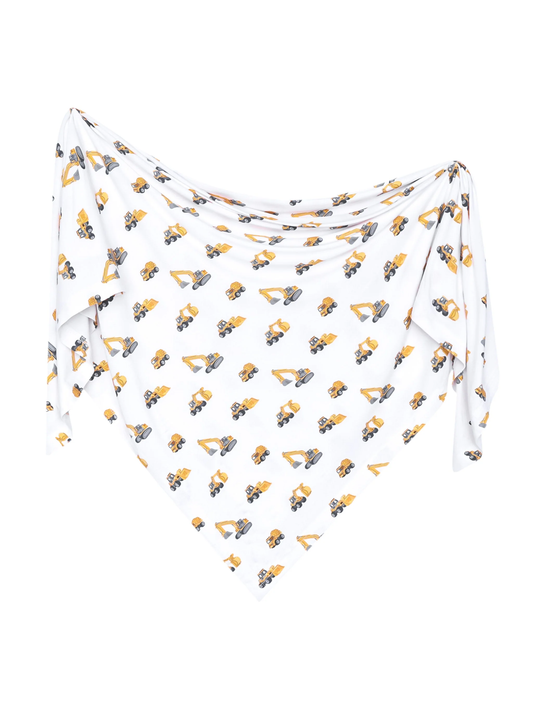 White bamboo swaddle blanket with yellow construction excavator and truck print
