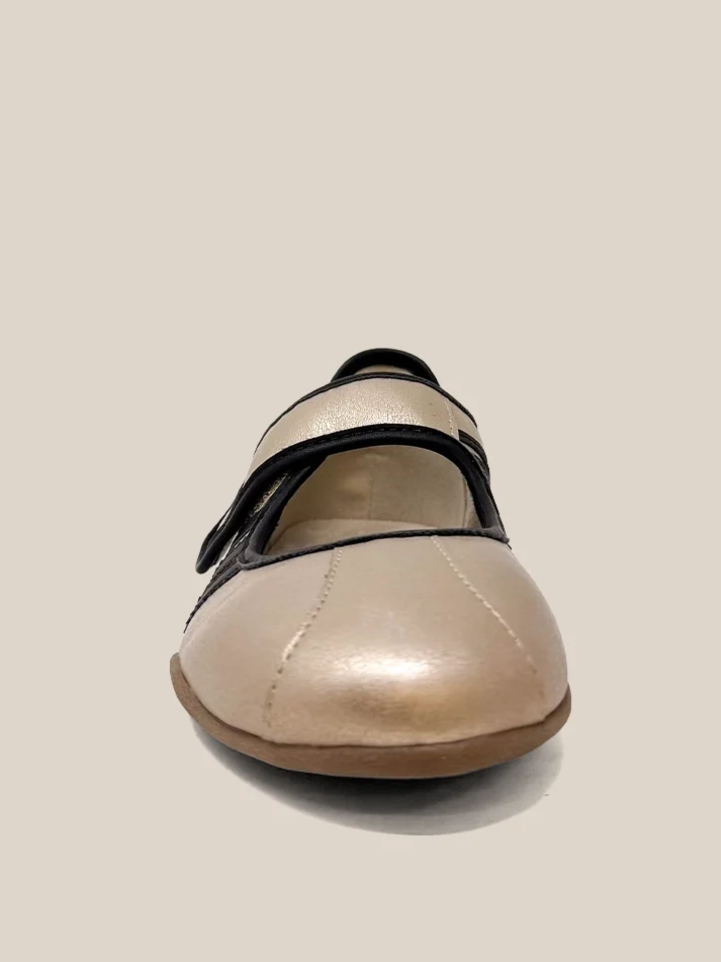 Gold metallic mary jane flat sneaker with black velcro strap, front view