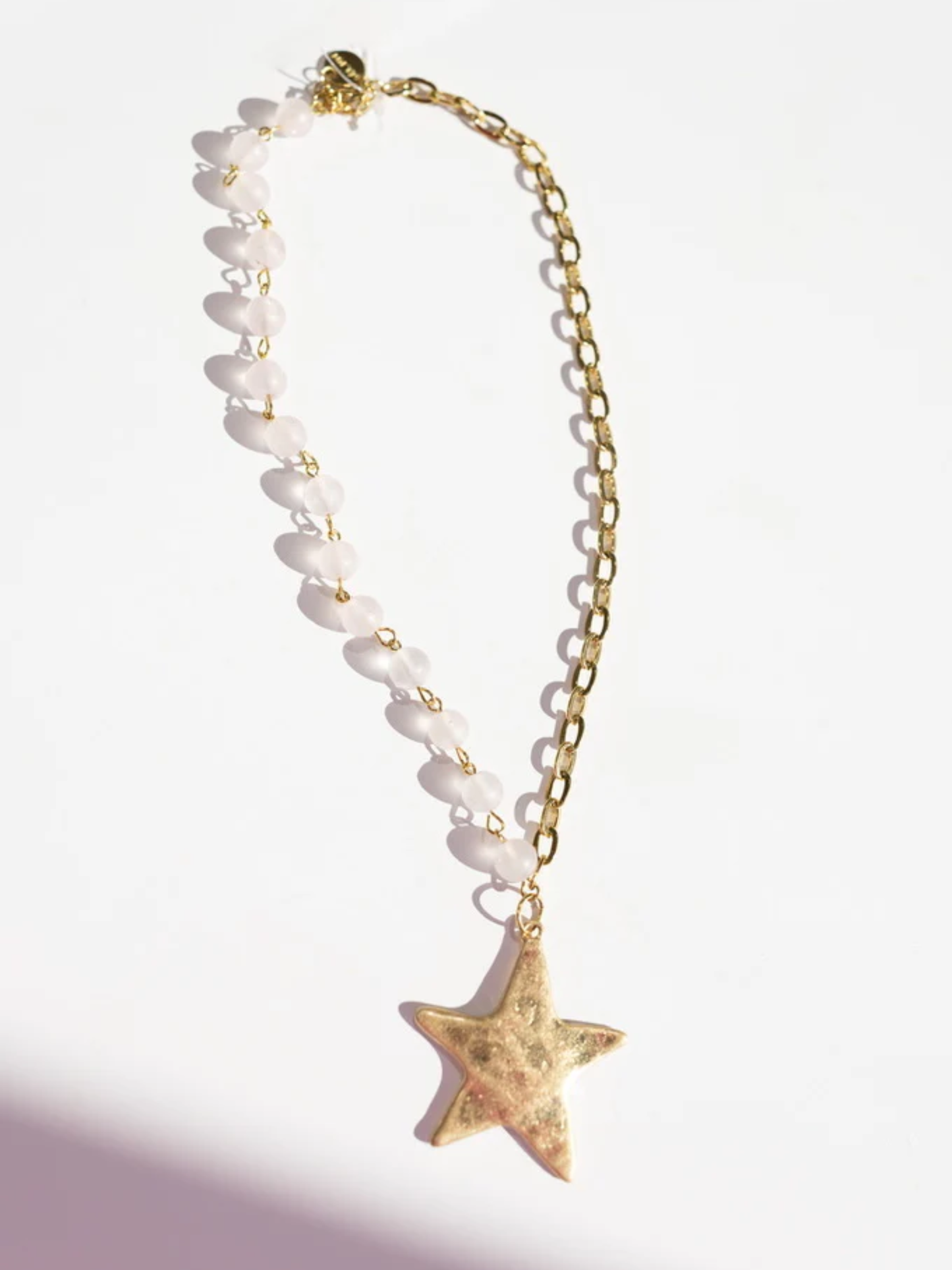 Gold star pendant necklace with frosted white beaded chain and gold curb chain