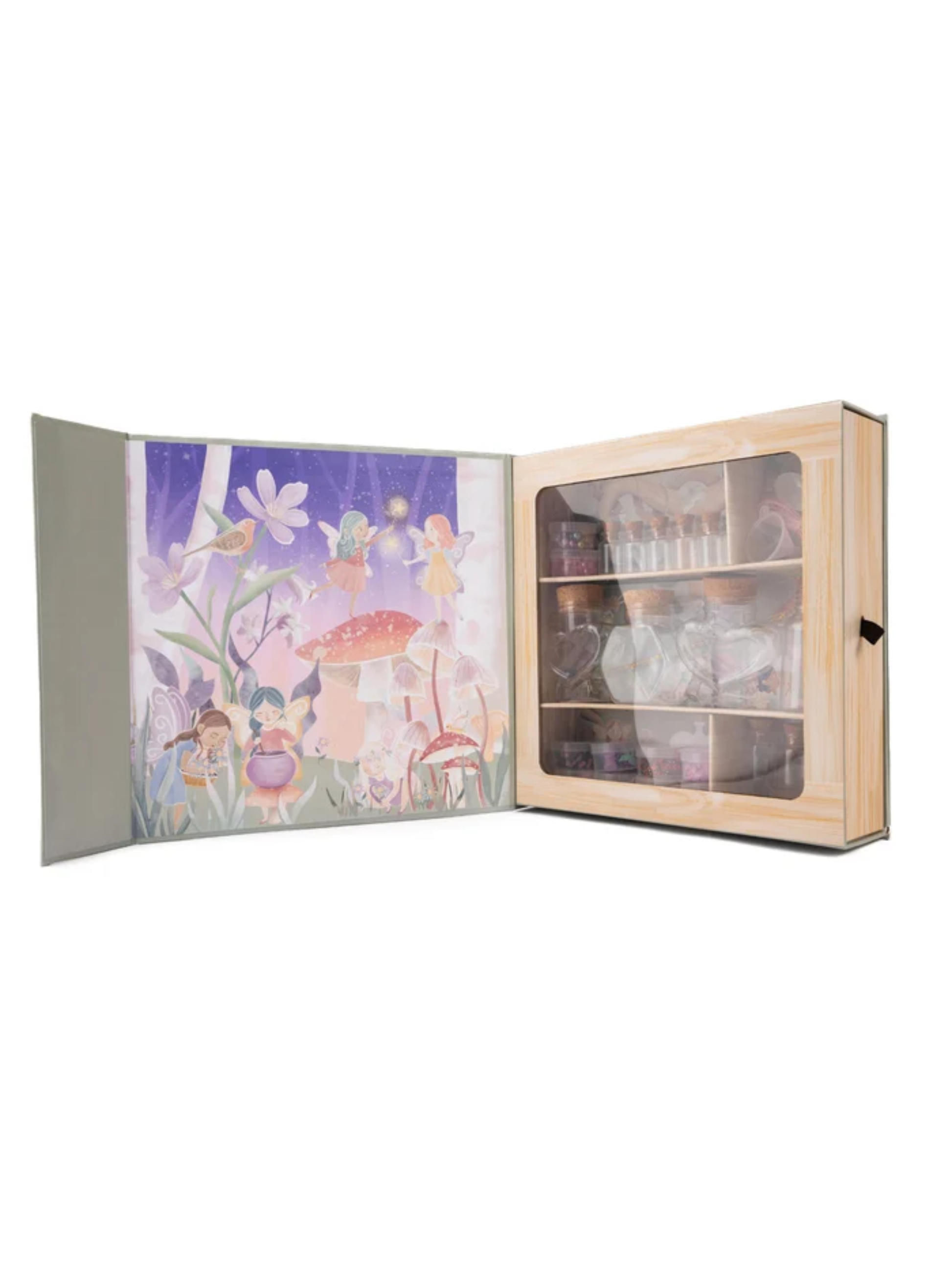 Open fairy-themed potion kit box with illustrated woodland scene and glass vials on wooden shelves