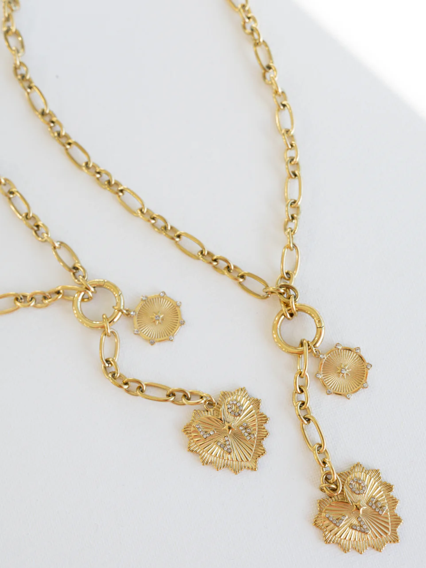 Gold chain necklace with crystal-accented heart and circular coin charms