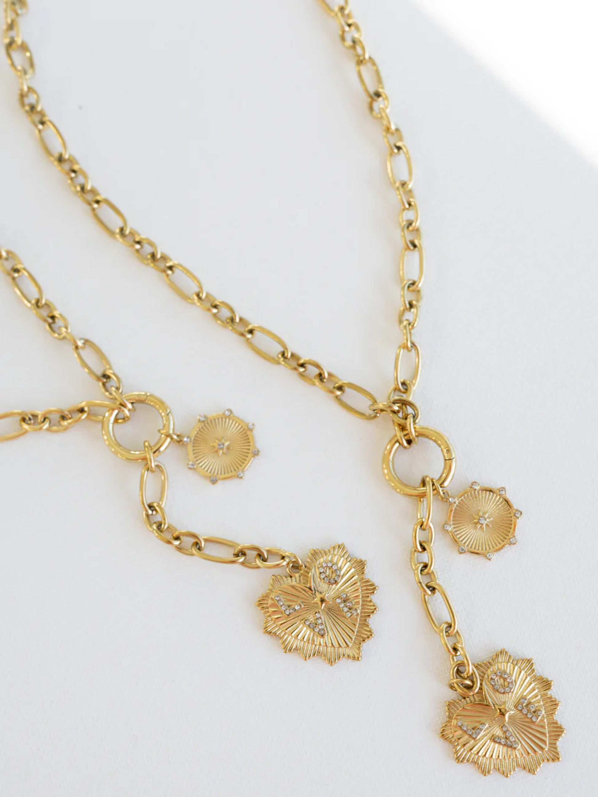 Gold chain necklace with crystal-accented heart and circular coin charms
