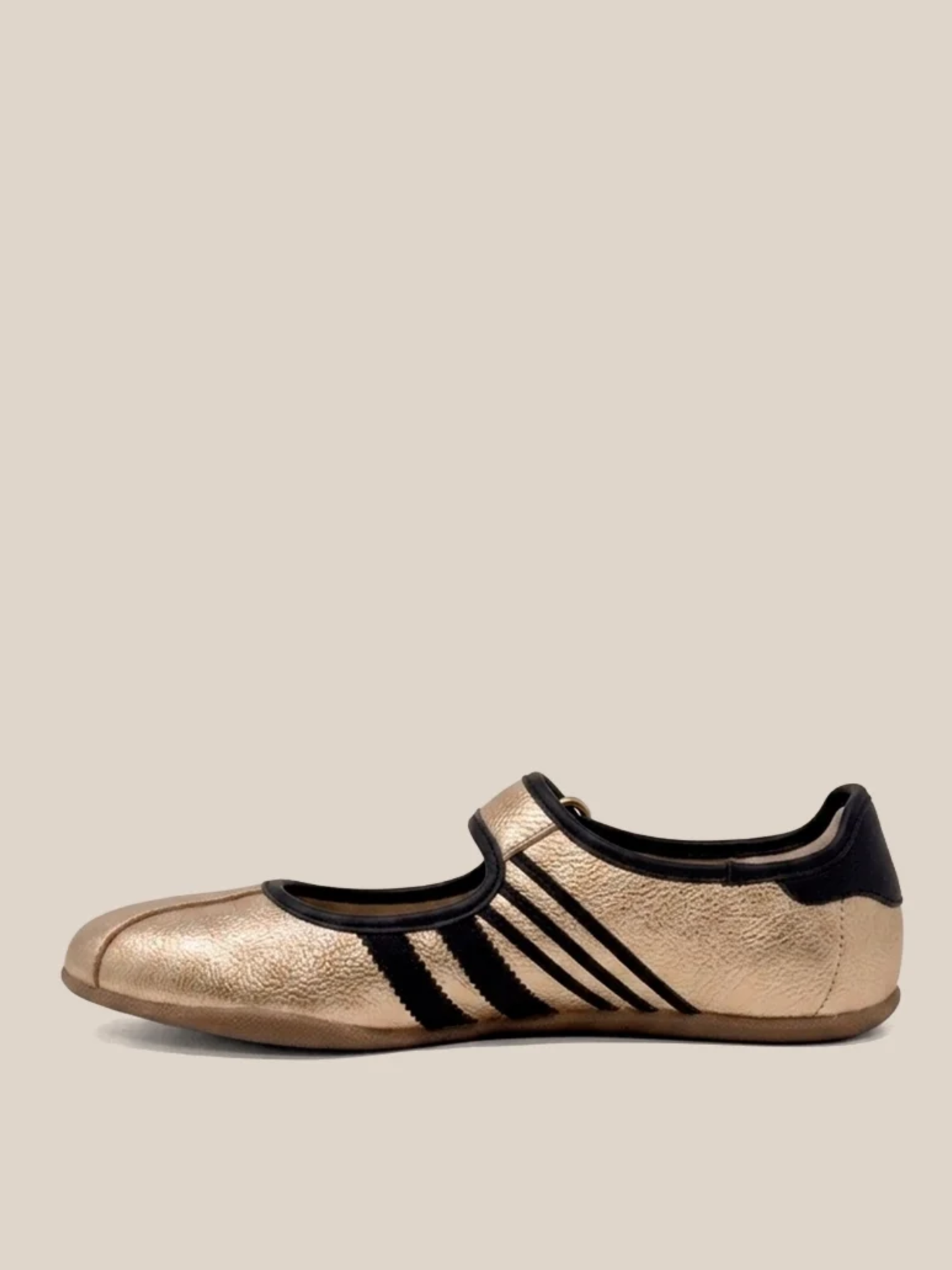 Gold metallic Mary Jane flat sneaker with three black stripes and ankle strap