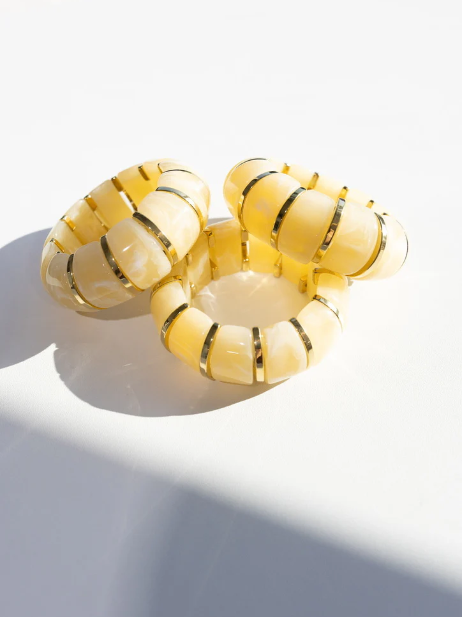 soft cream-colored resin beads with 18k gold plated stainless steel accents stretch bracelet